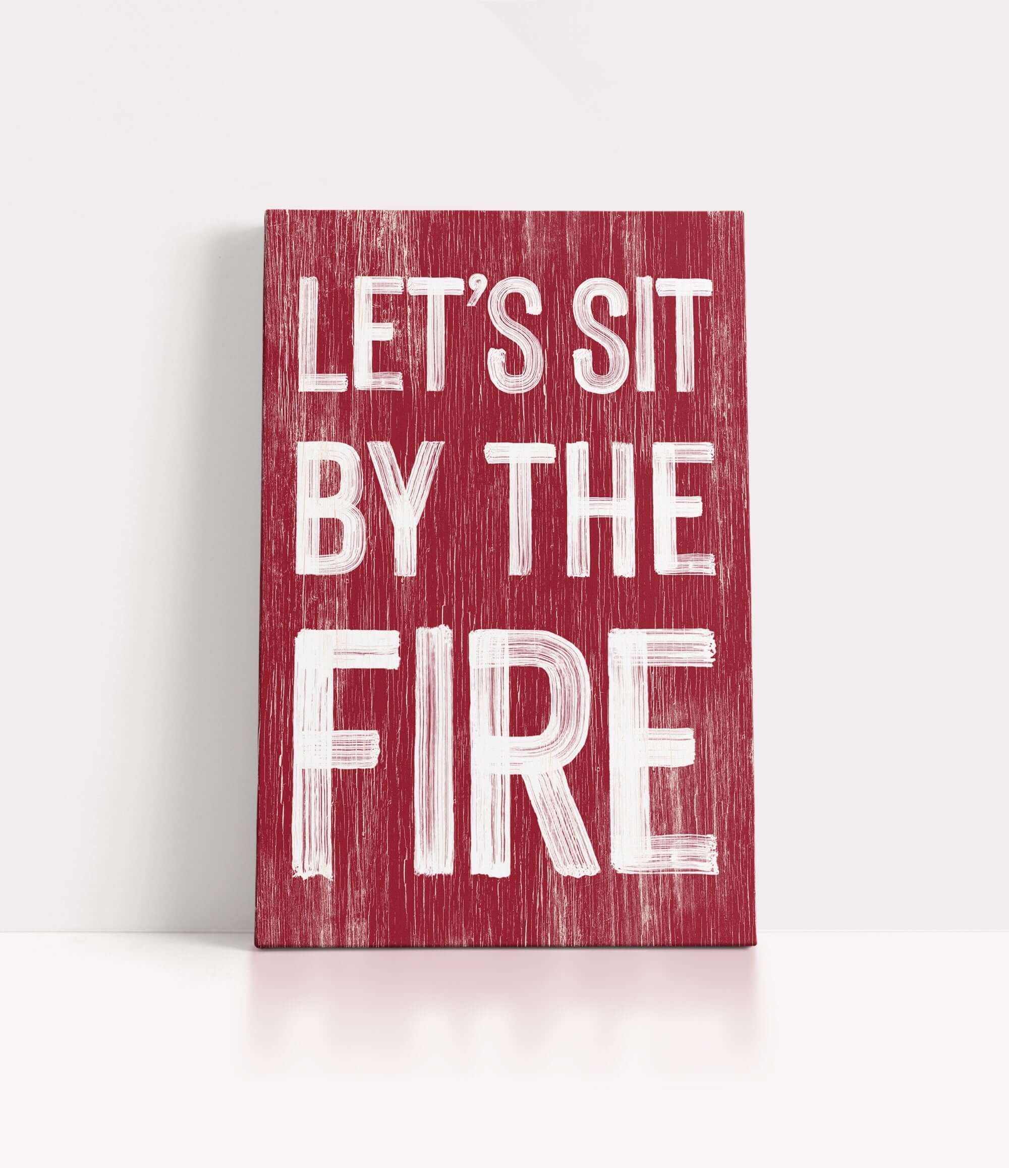 a red sign that says let's sit by the fire