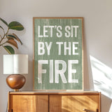 a picture of a sign that says let's sit by the fire