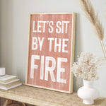 a wooden sign that says let's sit by the fire