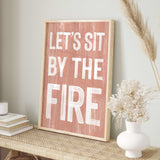 a wooden sign that says let's sit by the fire