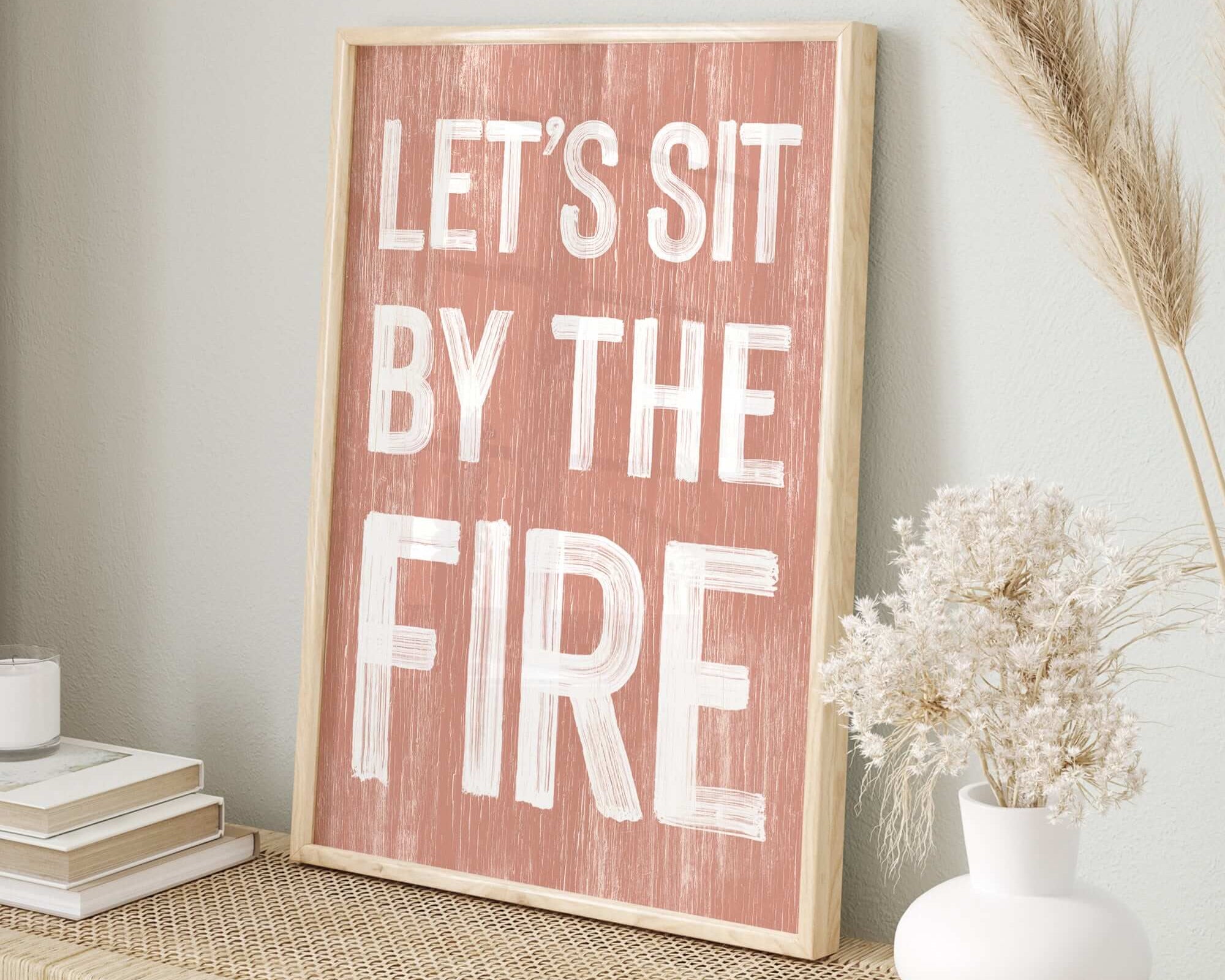 a wooden sign that says let's sit by the fire