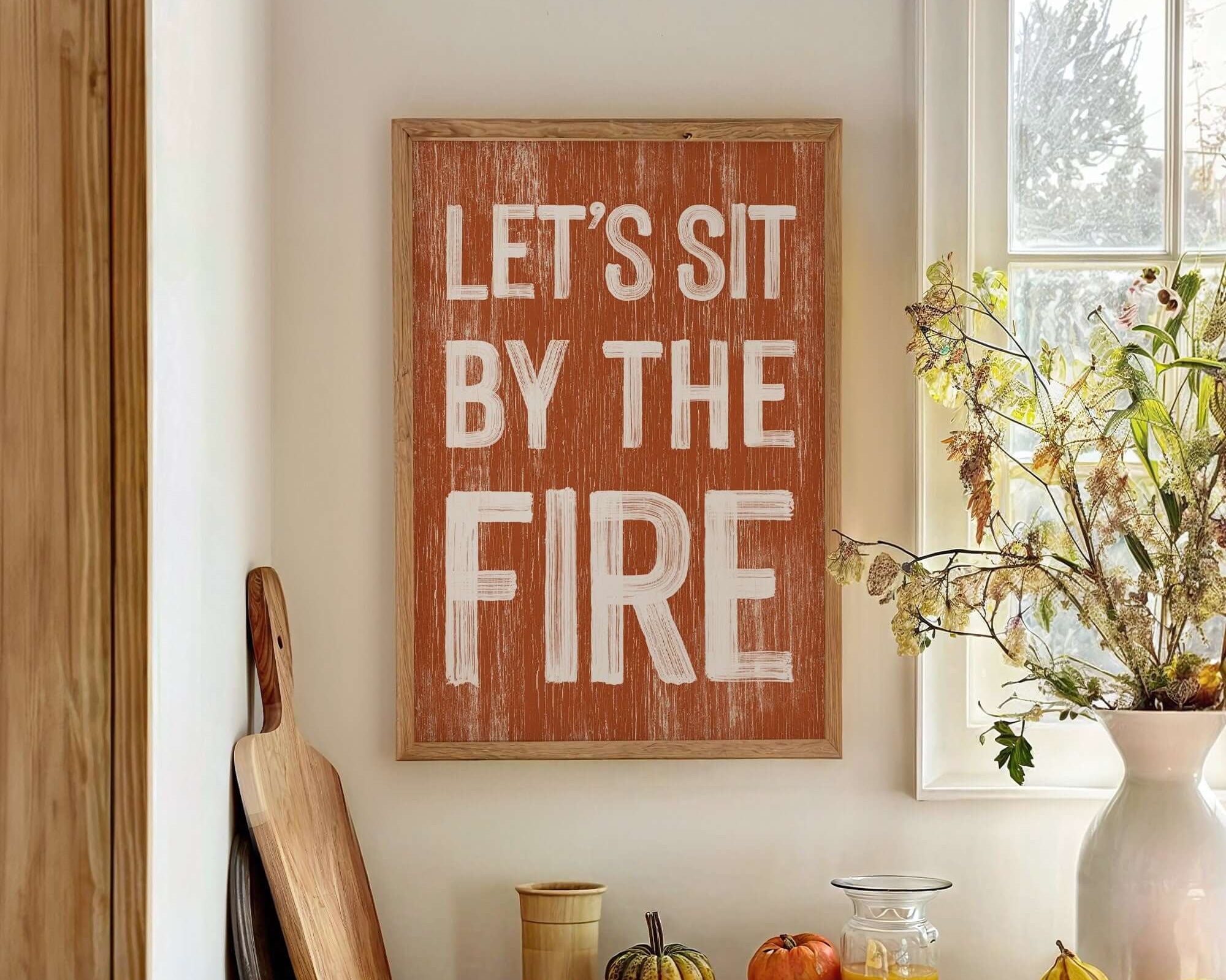 a wooden sign that says let's sit by the fire