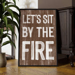 a wooden sign that says, let's sit by the fire