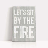 a wooden sign that says let's sit by the fire