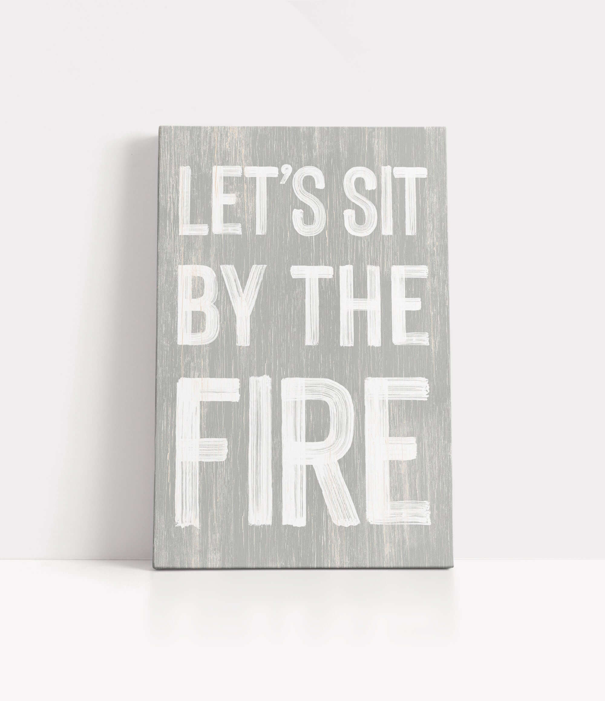 a wooden sign that says let's sit by the fire