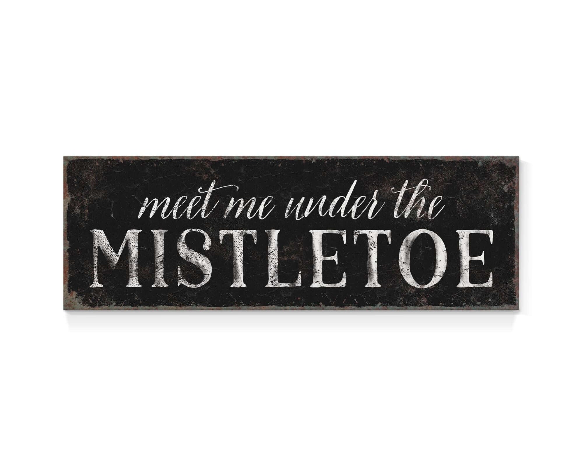 a sign that says meet me under the mistletoe