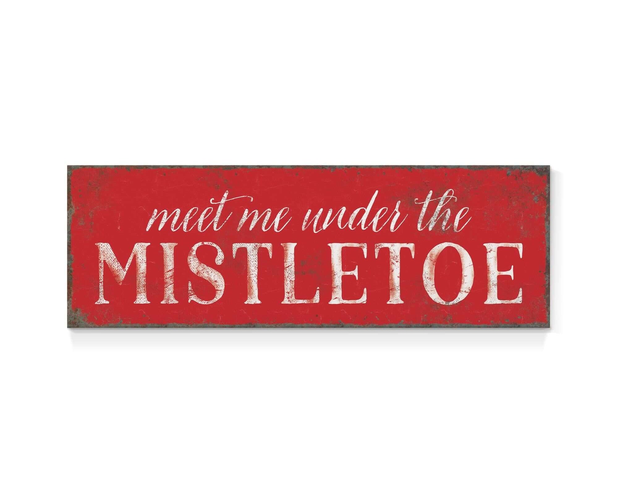 a red sign that says meet me under the mistletoe