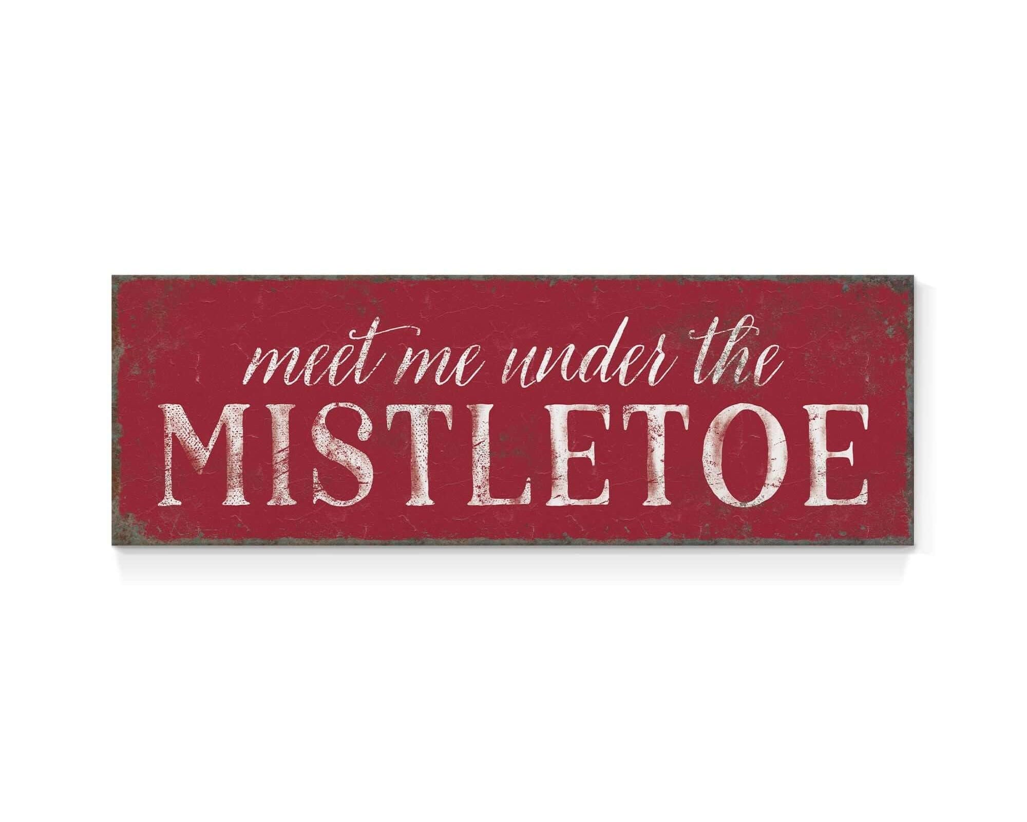a red sign that says meet me under the mistletoe
