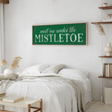 a bedroom with a white bed and a green sign on the wall