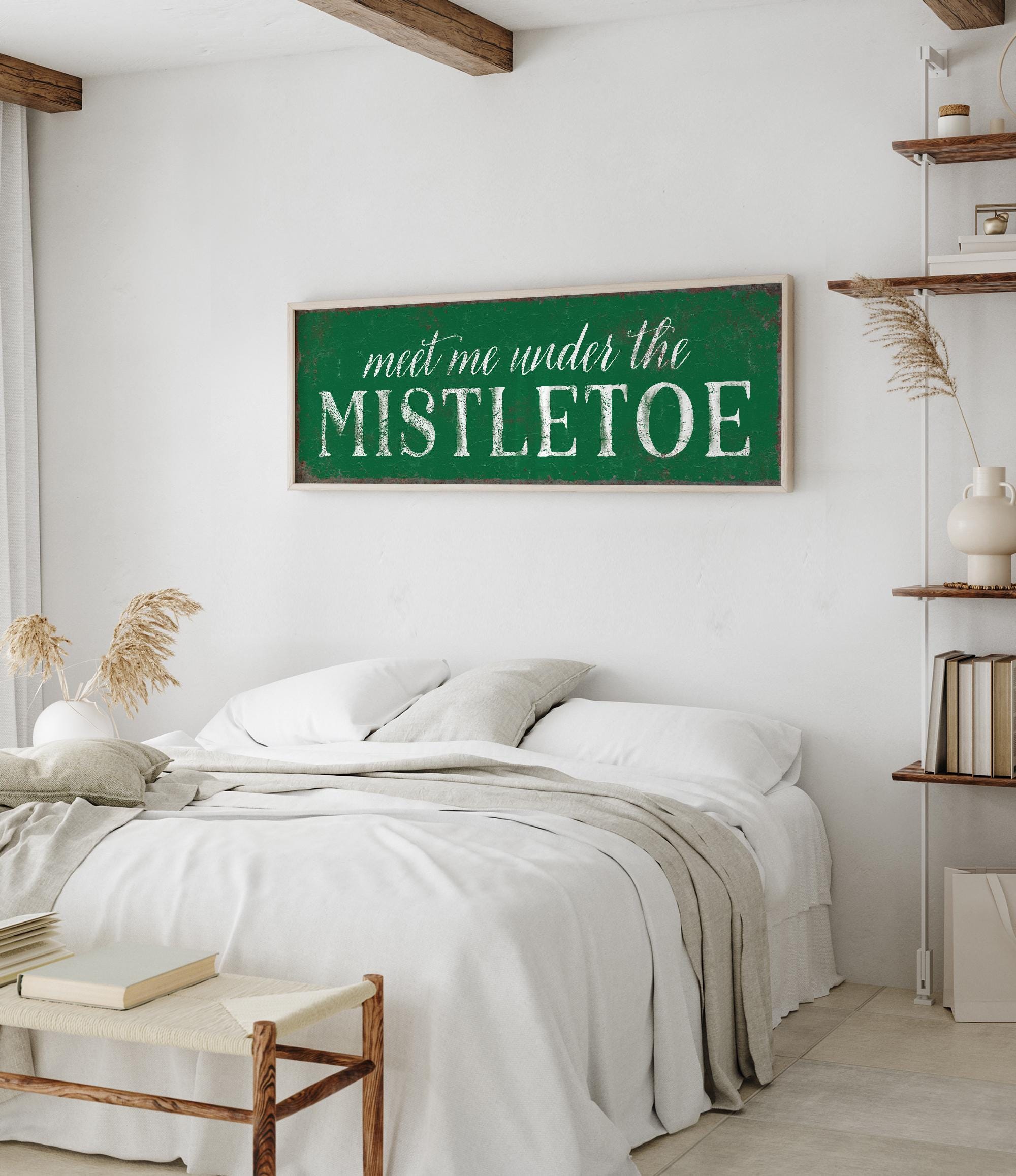 a bedroom with a white bed and a green sign on the wall