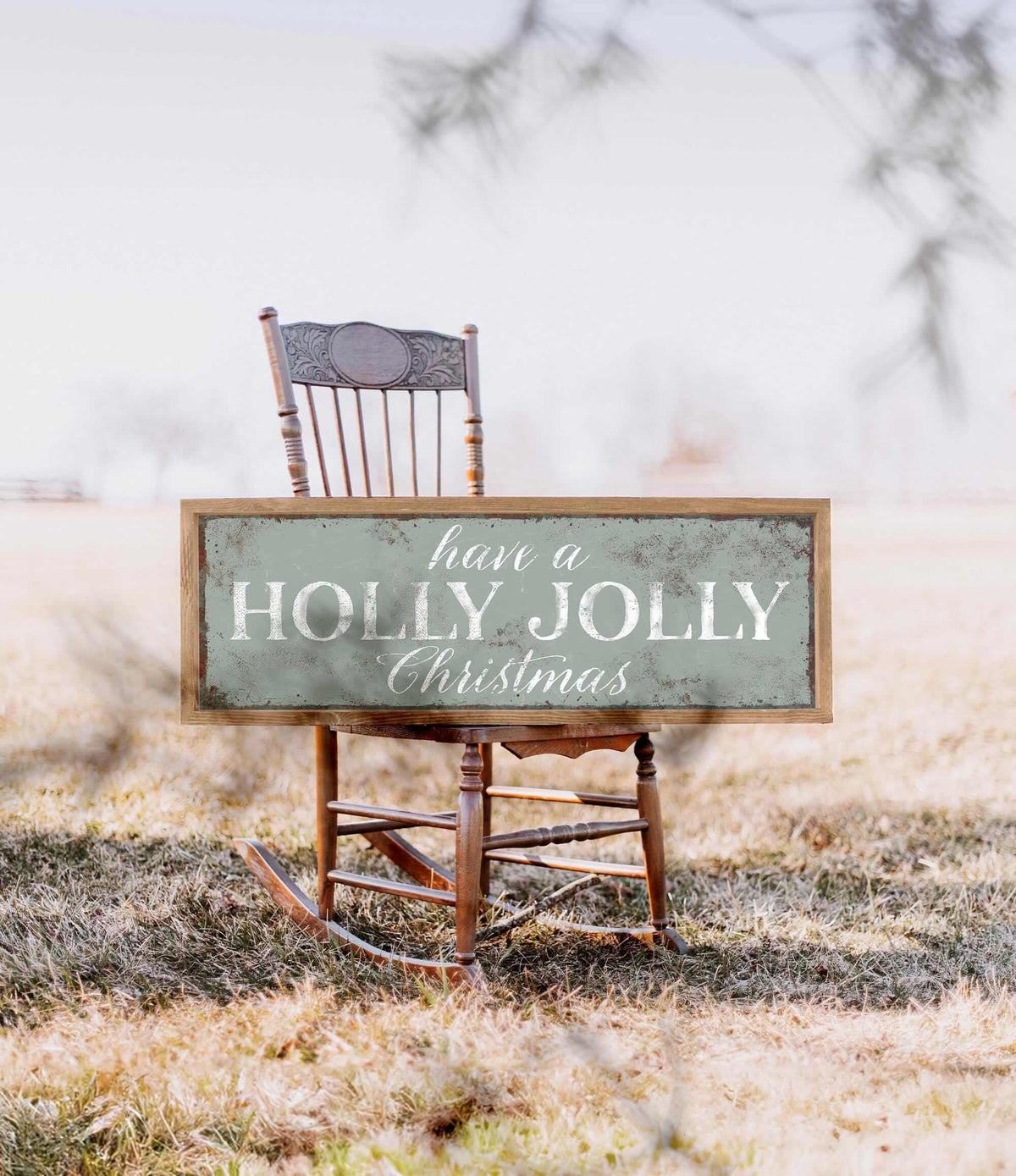 a wooden rocking chair with a sign that says have a holly christmas