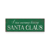 a green sign that says i saw mommy kissing santa claus