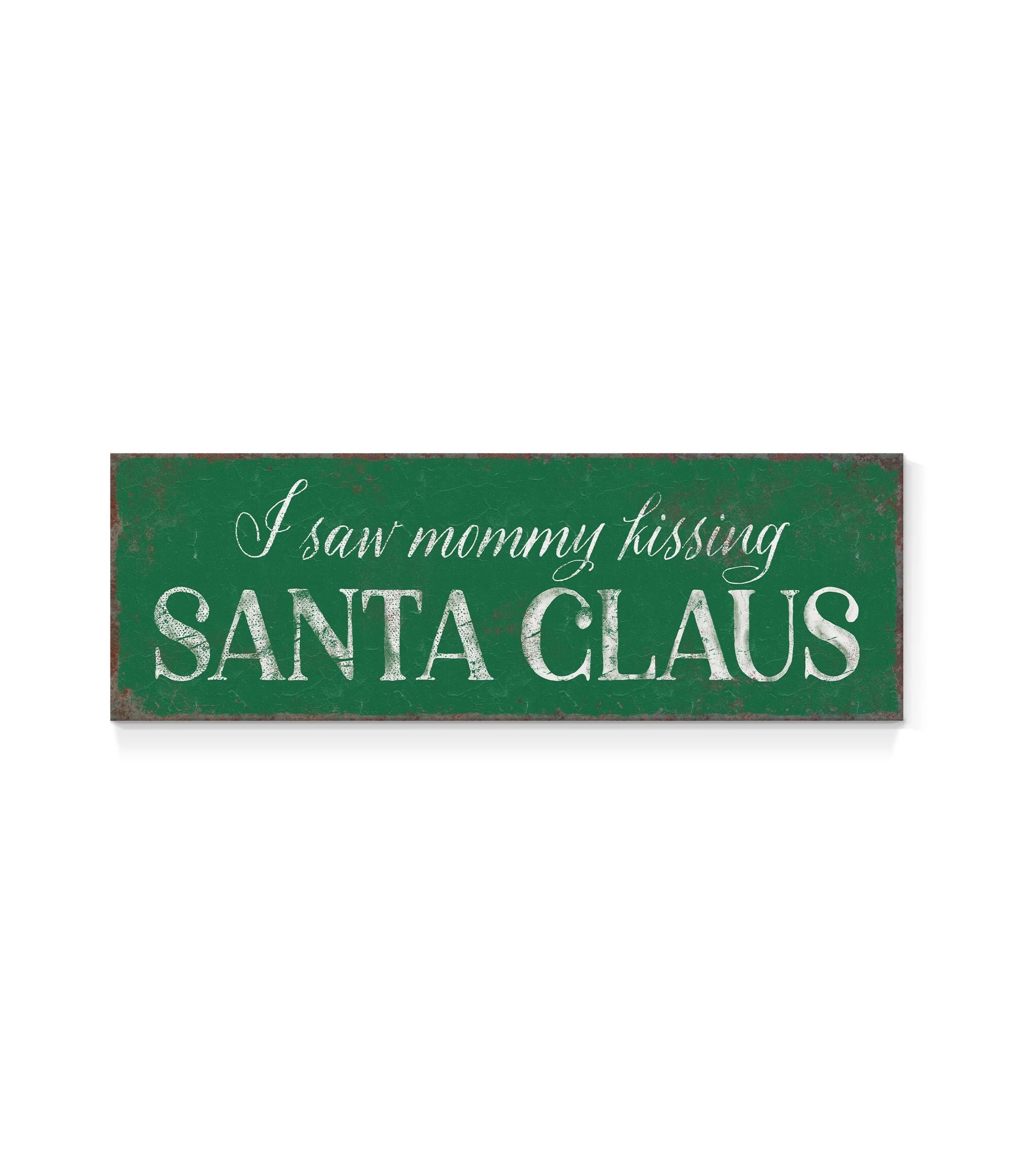 a green sign that says i saw mommy kissing santa claus