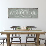 a dining room table with a wooden sign above it