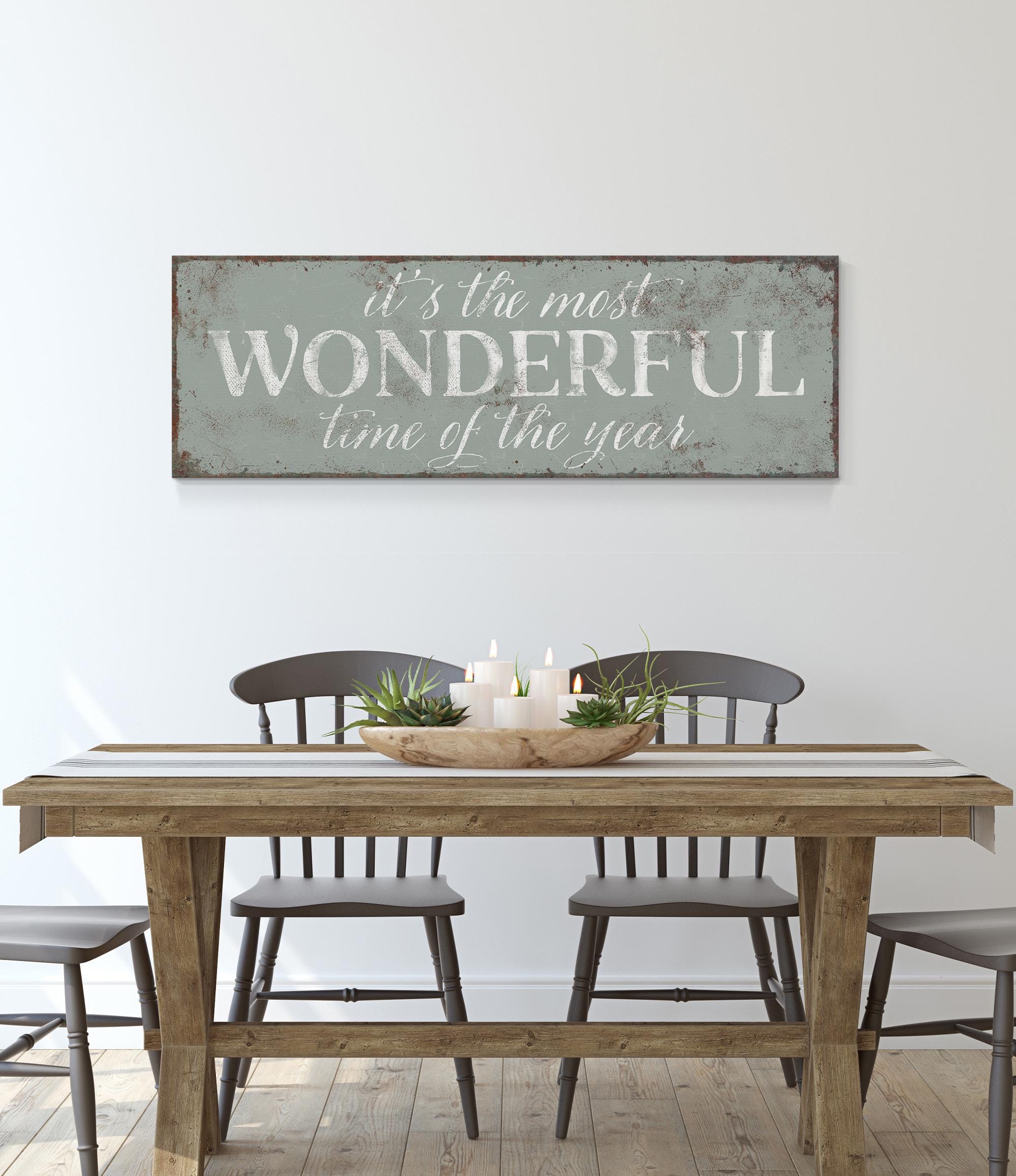 a dining room table with a wooden sign above it