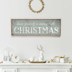 a fireplace mantle with a christmas sign above it