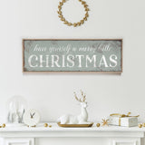 a fireplace mantle with a christmas sign above it