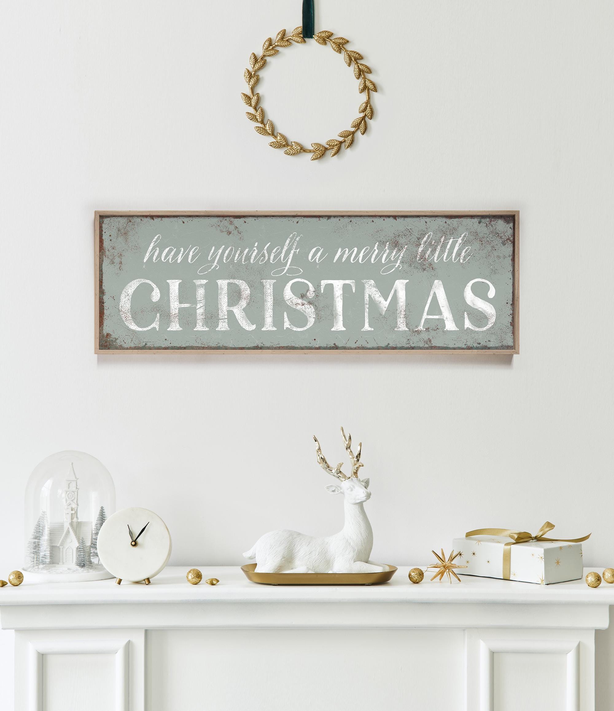 a fireplace mantle with a christmas sign above it