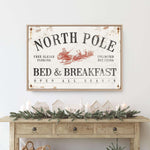 a christmas scene with a bed and breakfast sign