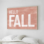 a picture of a bed with a hello fall sign above it