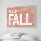 a picture of a bed with a hello fall sign above it