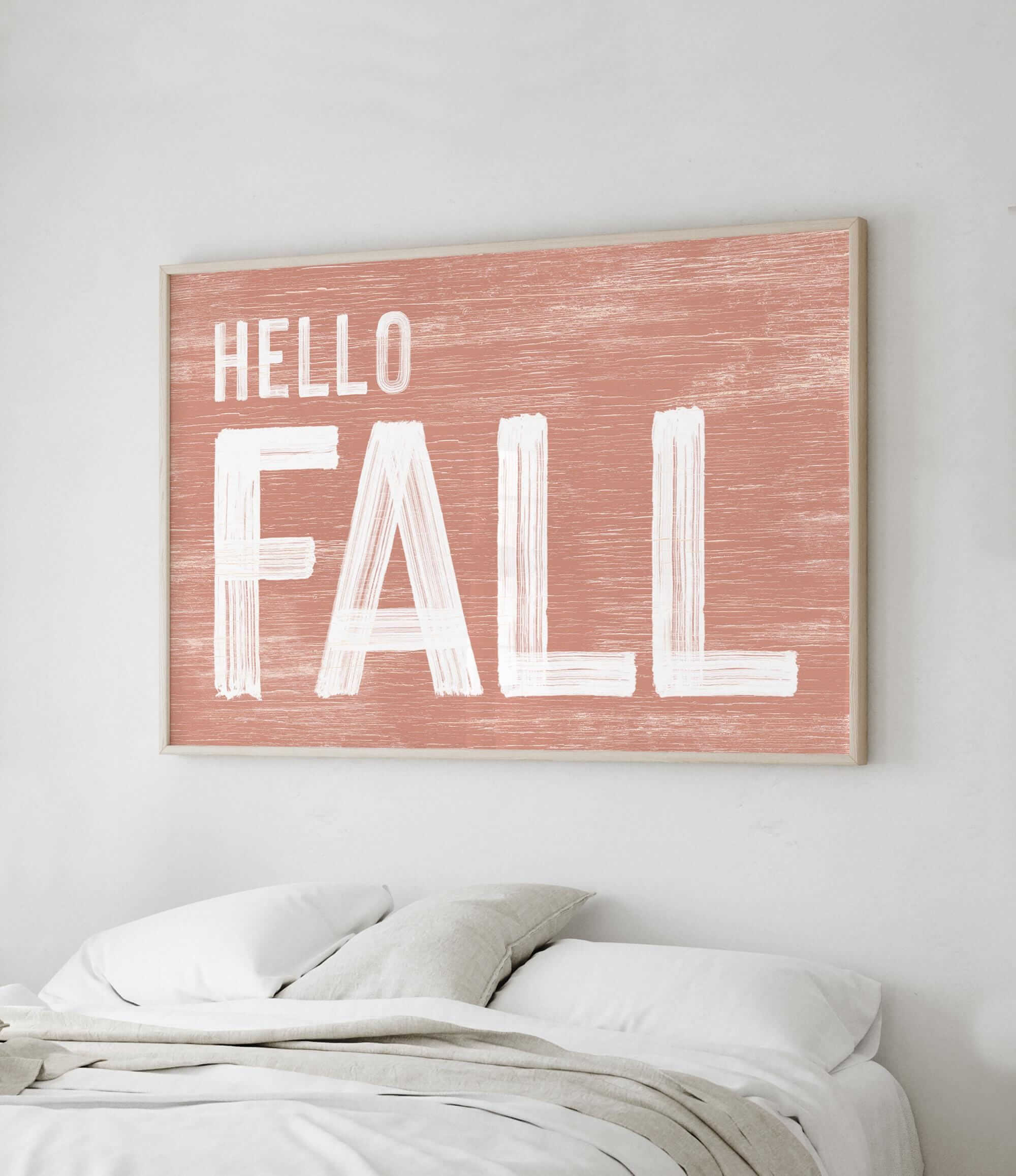 a picture of a bed with a hello fall sign above it