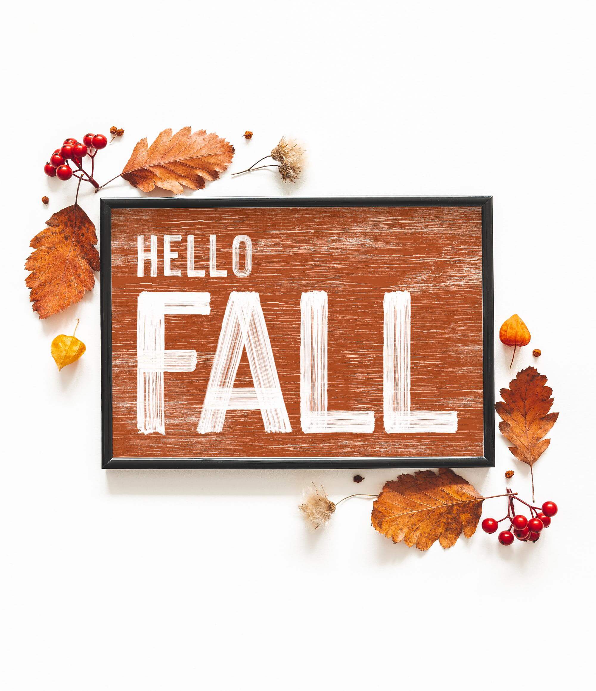 a wooden sign that says hello fall surrounded by autumn leaves