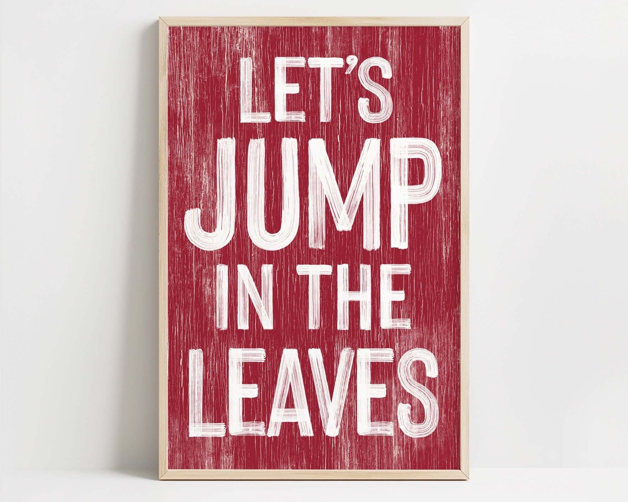 a red sign that says let's jump in the leaves