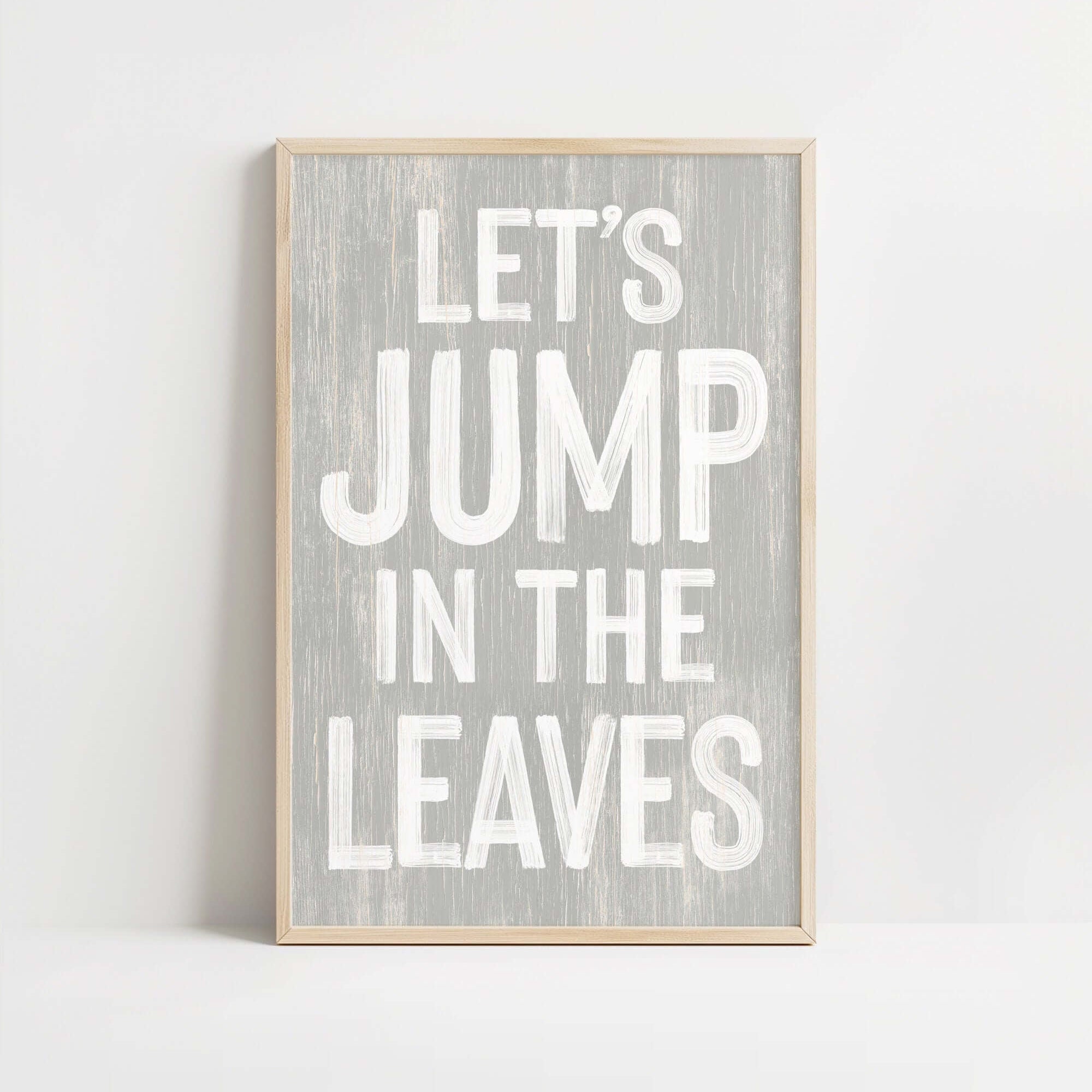a wooden sign that says let's jump in the leaves