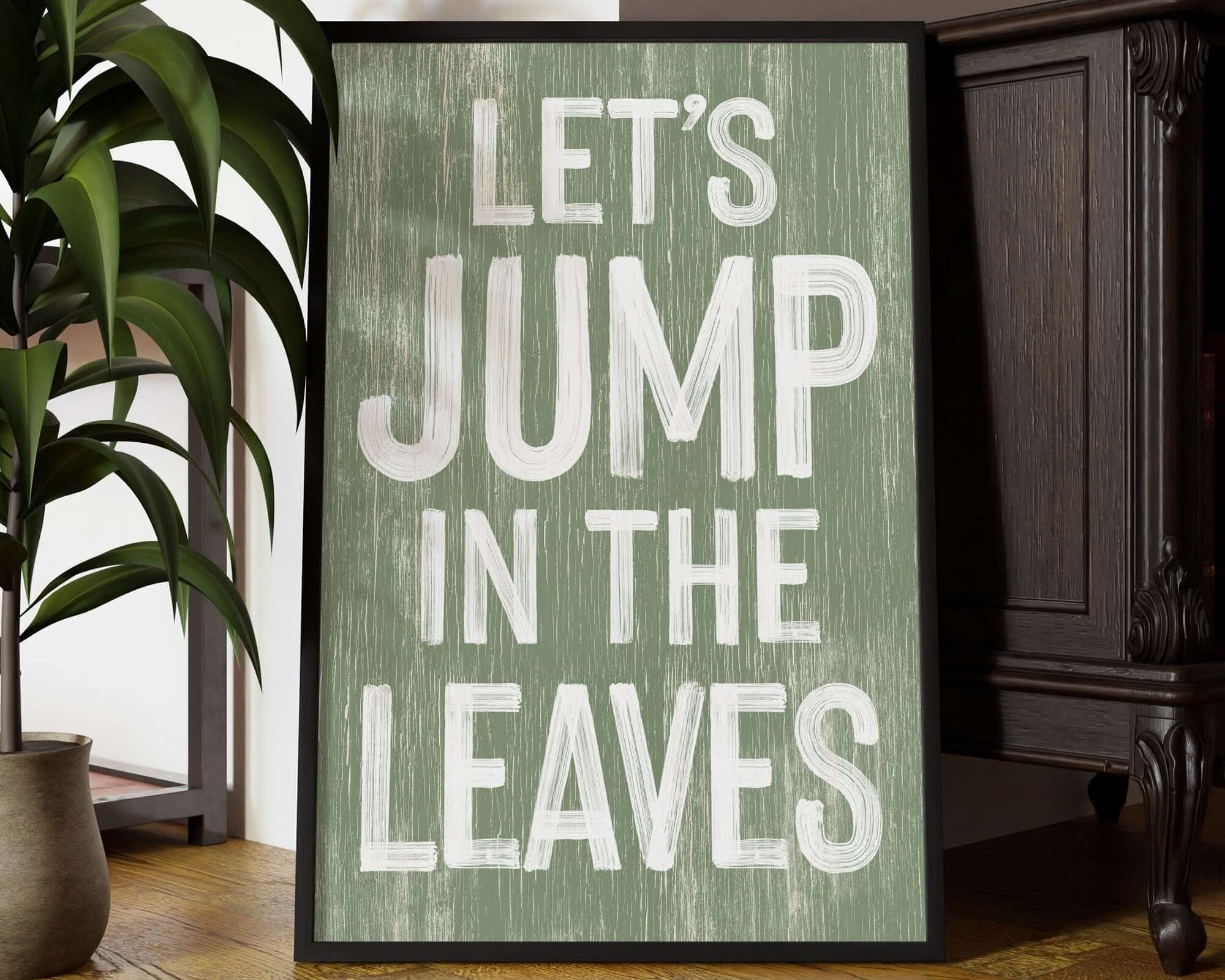 a sign that says let's jump in the leaves