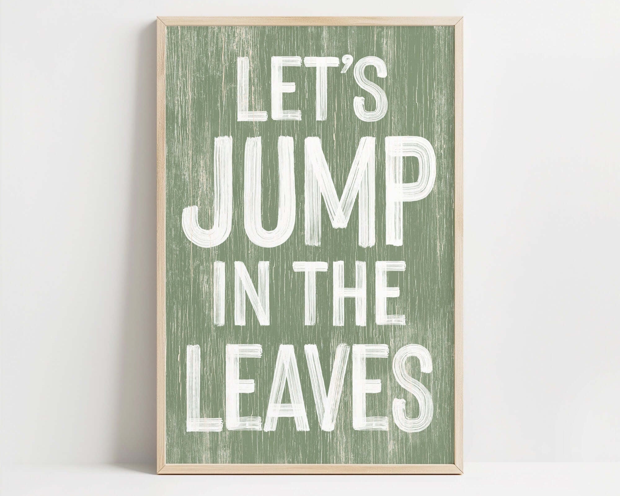 a wooden sign that says let's jump in the leaves