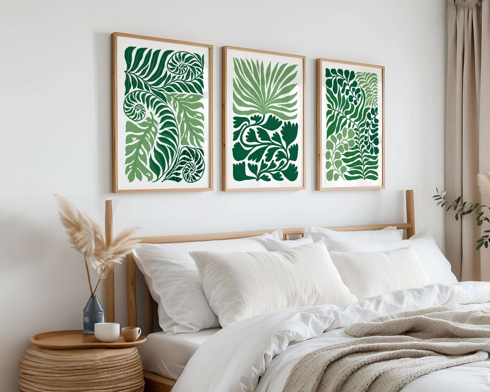 Minimalist bedroom with white bedding, wood accents, and the Tropical Blocks Triptych—a set of three botanical prints—above the bed, perfect for elevating your home decor.