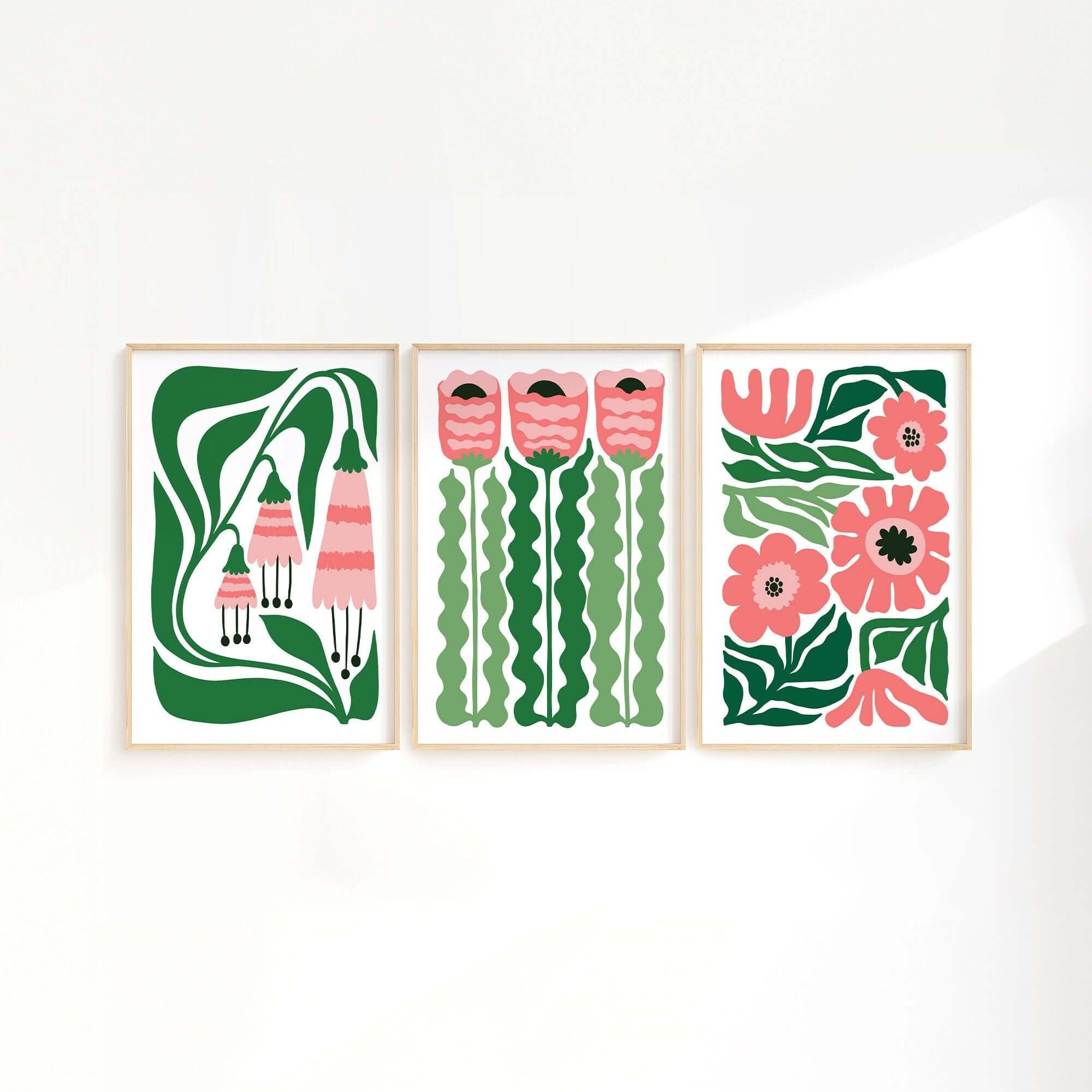 The Tropical Blocks Triptych (Set of Three Prints | 414) features abstract pink and green floral designs, creating a striking wall art collection that beautifully elevates any home decor on a white wall.