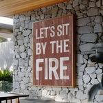 a sign that says let's sit by the fire