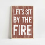 a wooden sign that says let's sit by the fire