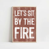 a wooden sign that says let's sit by the fire