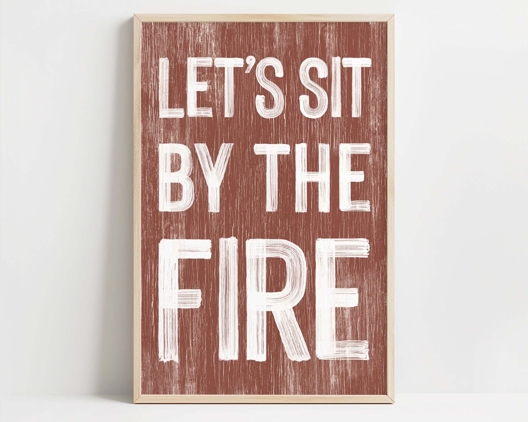 a wooden sign that says let's sit by the fire