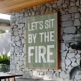 a sign that says let's sit by the fire