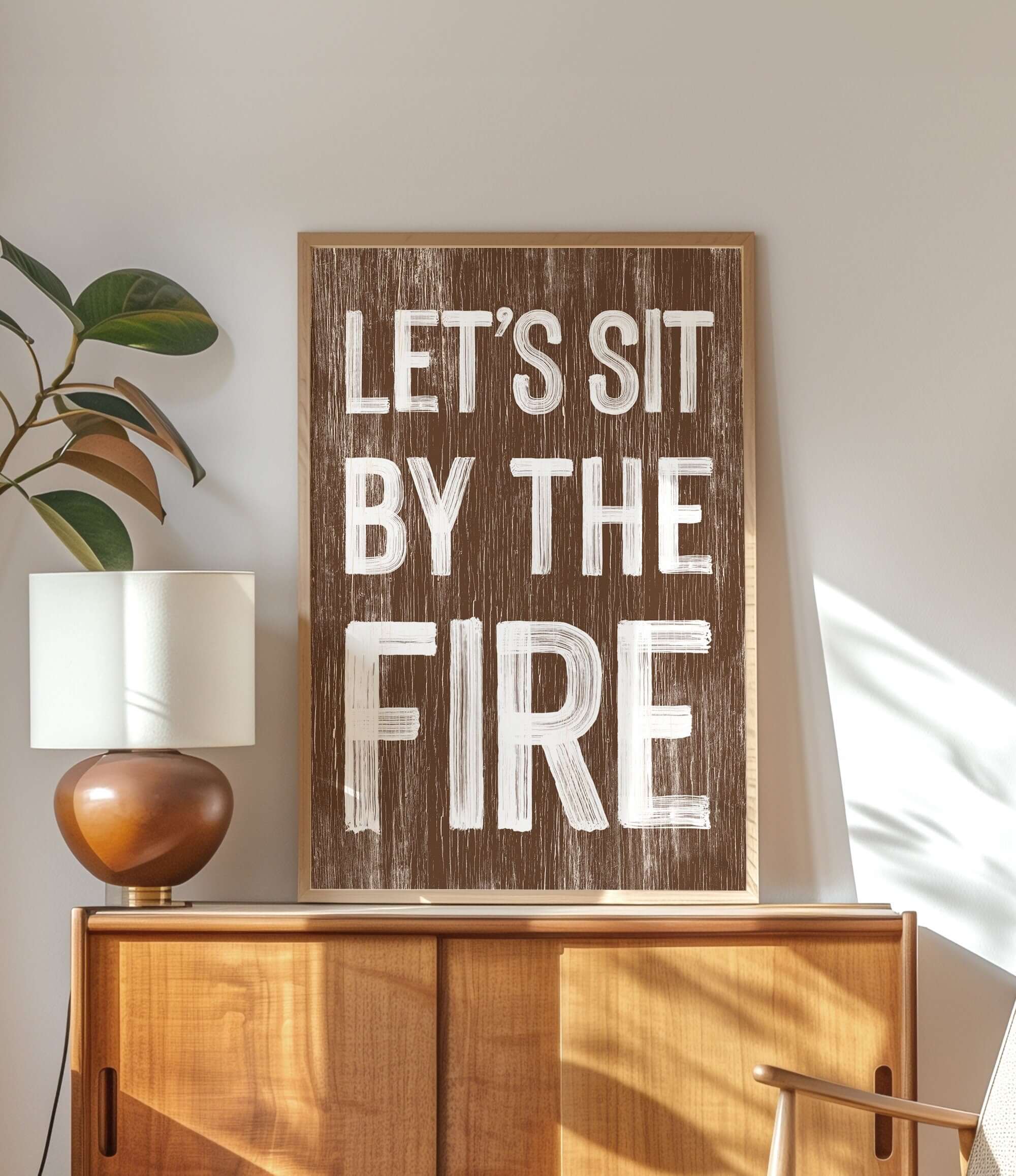 a wooden sign that says let's sit by the fire