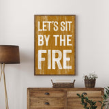 a wooden sign that says let's sit by the fire