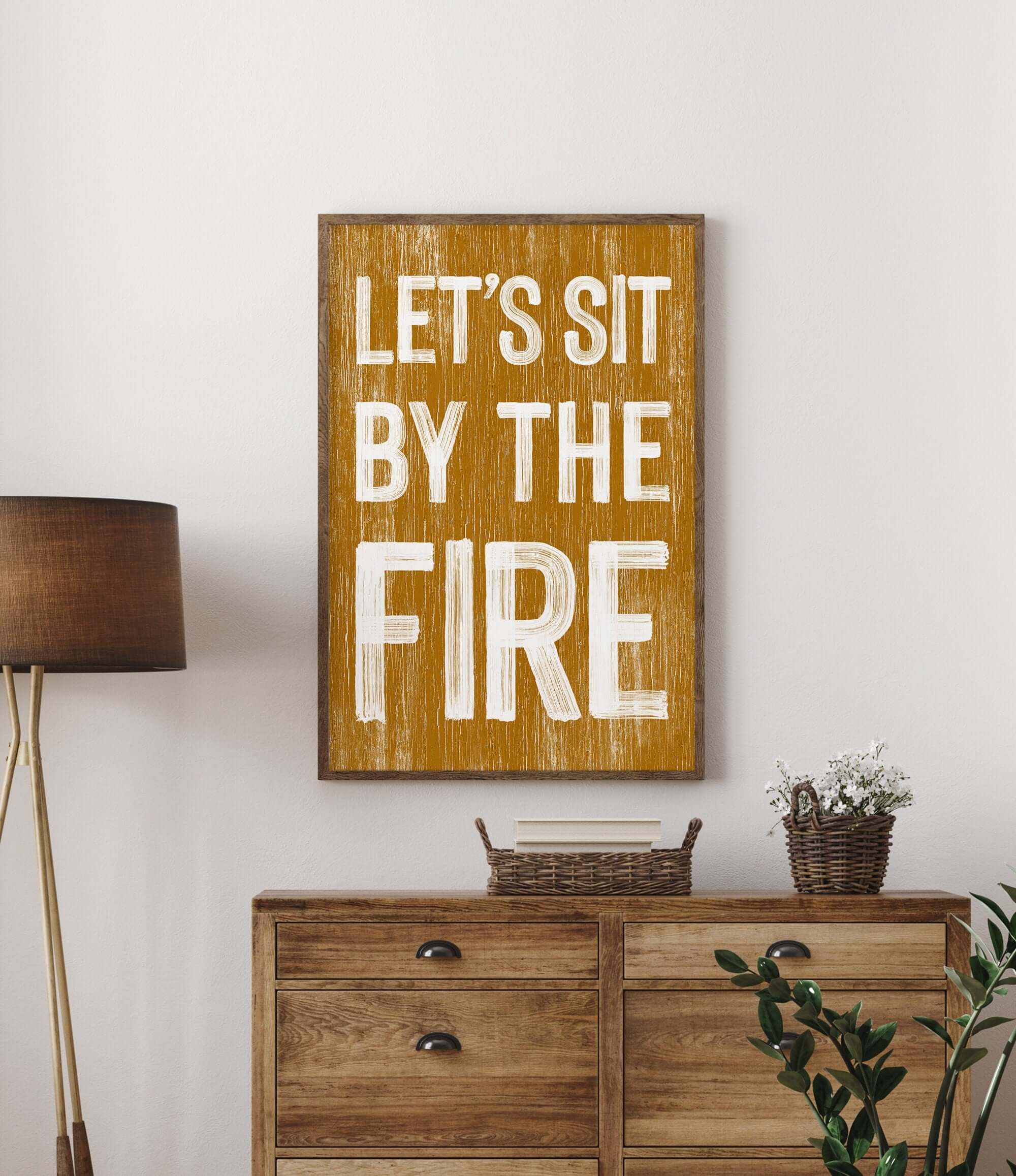 a wooden sign that says let's sit by the fire