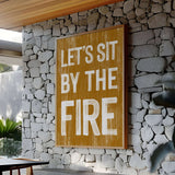 a sign that says let's sit by the fire