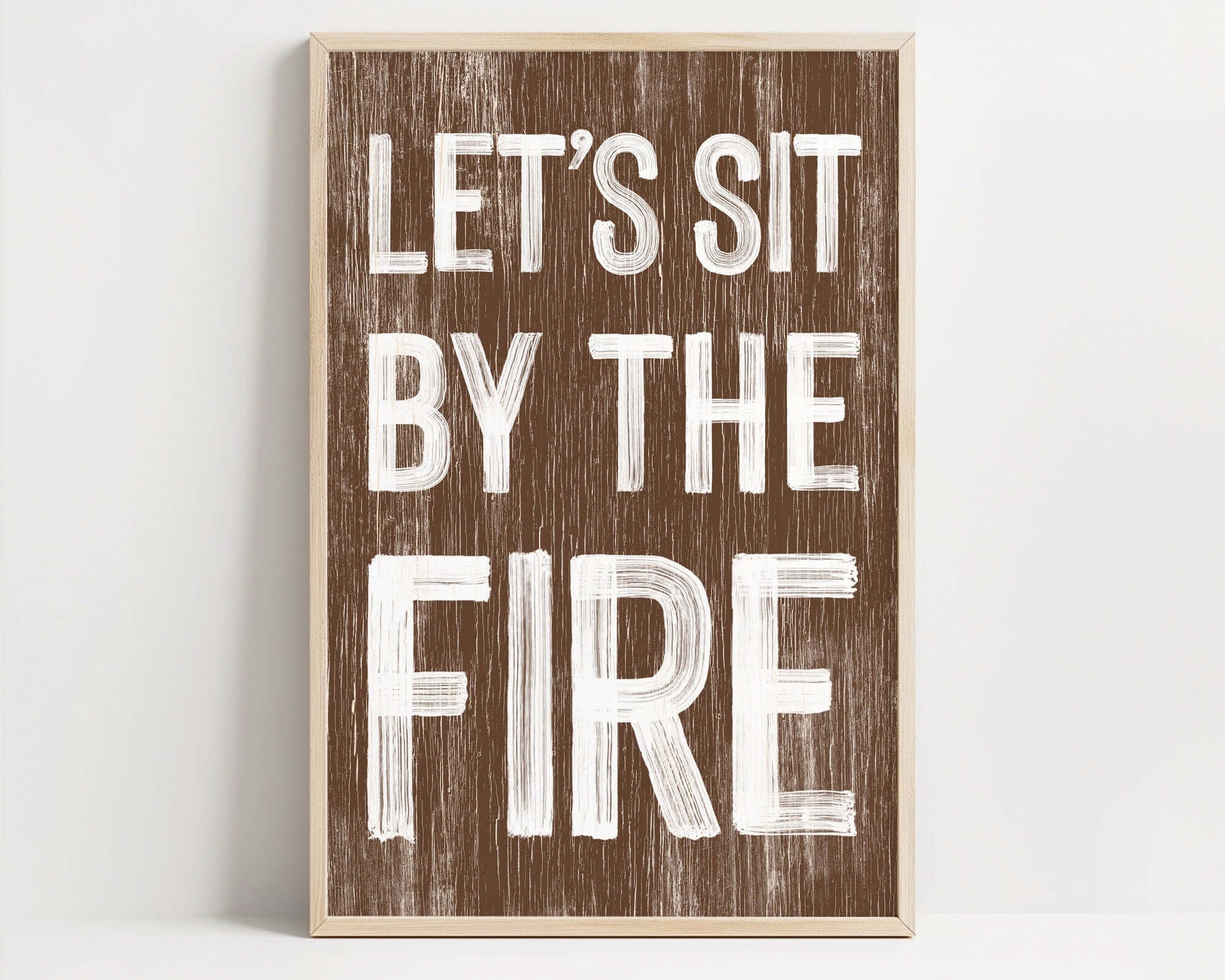 a wooden sign that says let's sit by the fire