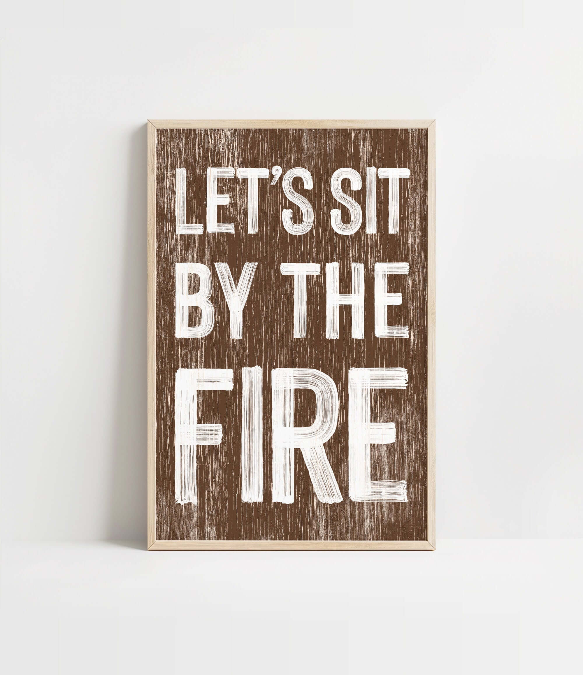 a wooden sign that says let's sit by the fire