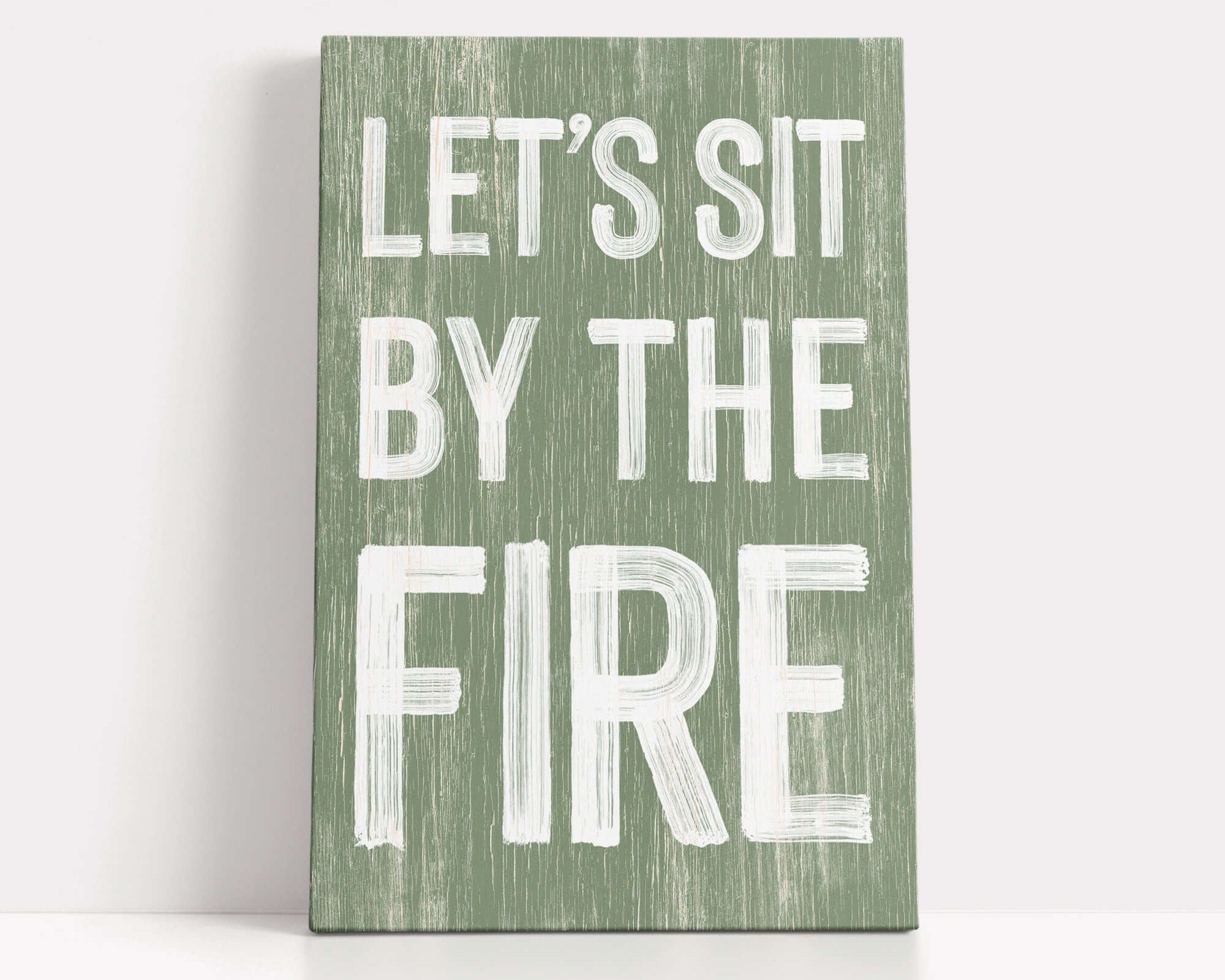 a wooden sign that says let's sit by the fire