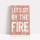 a wooden sign that says let's sit by the fire