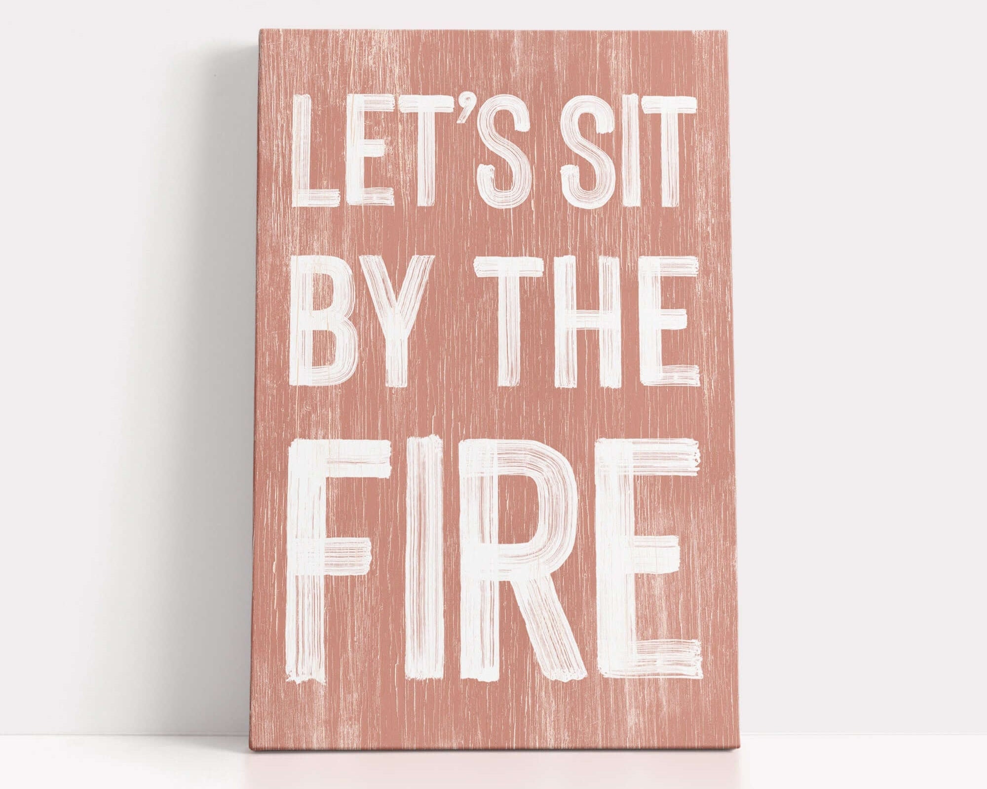 a wooden sign that says let's sit by the fire