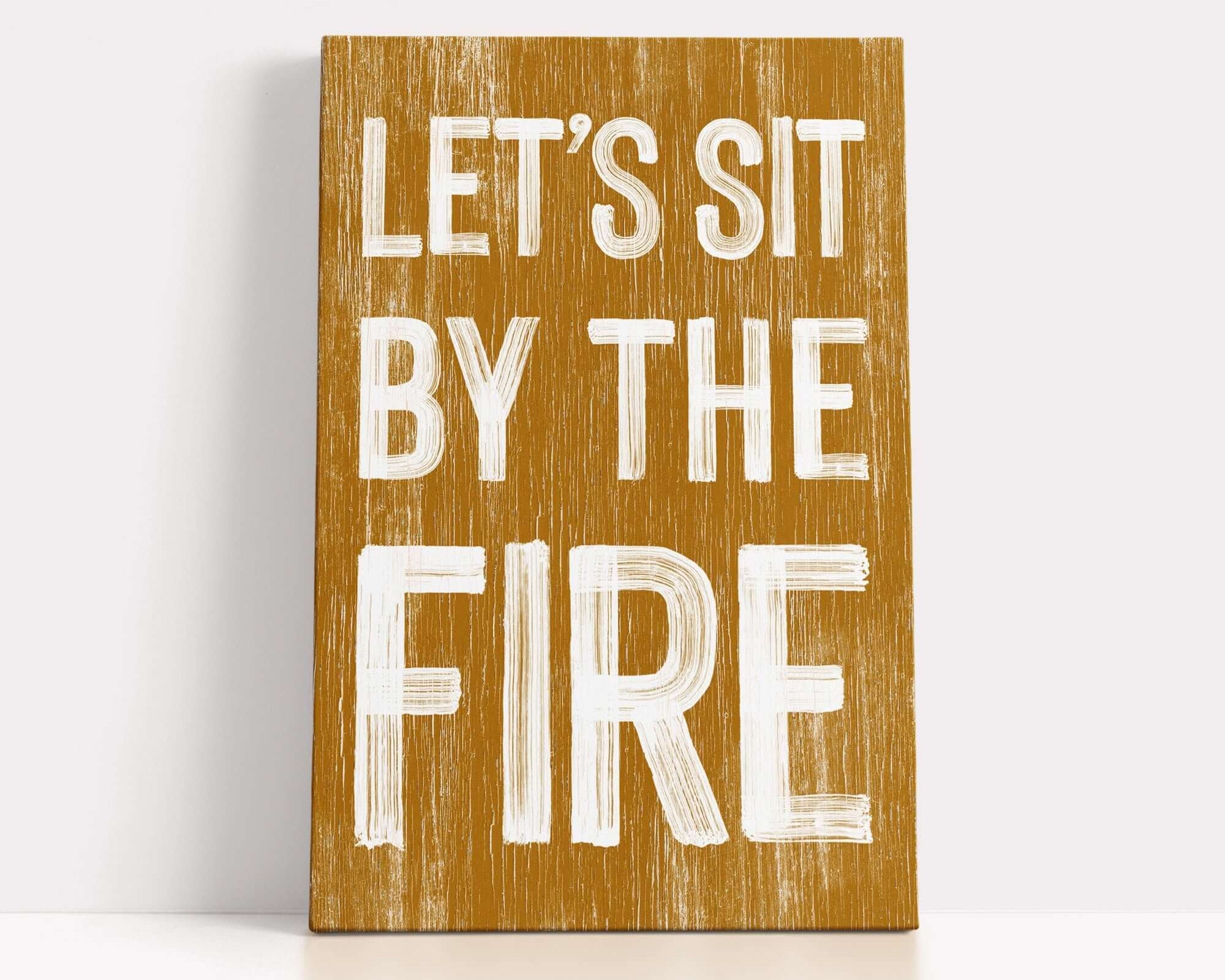 a wooden sign that says let's sit by the fire