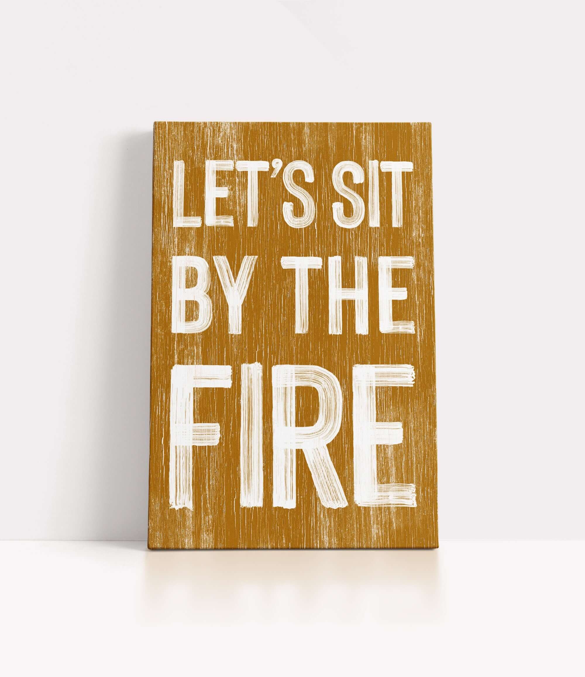 a wooden sign that says let's sit by the fire