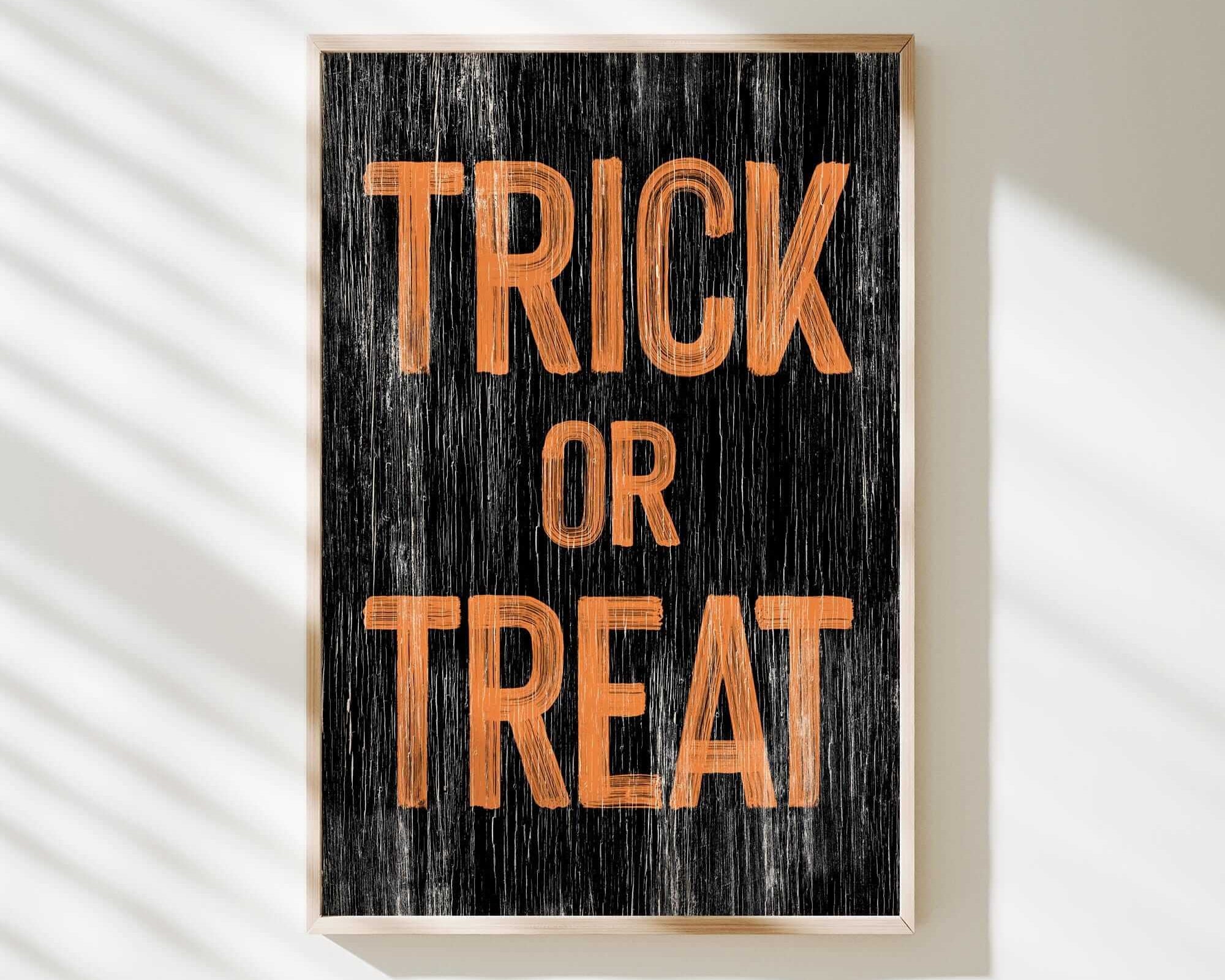 a trick or treat sign hanging on a wall